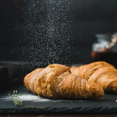 Fresh croissants on a dark board