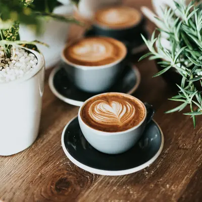 Flat whites on a timber table